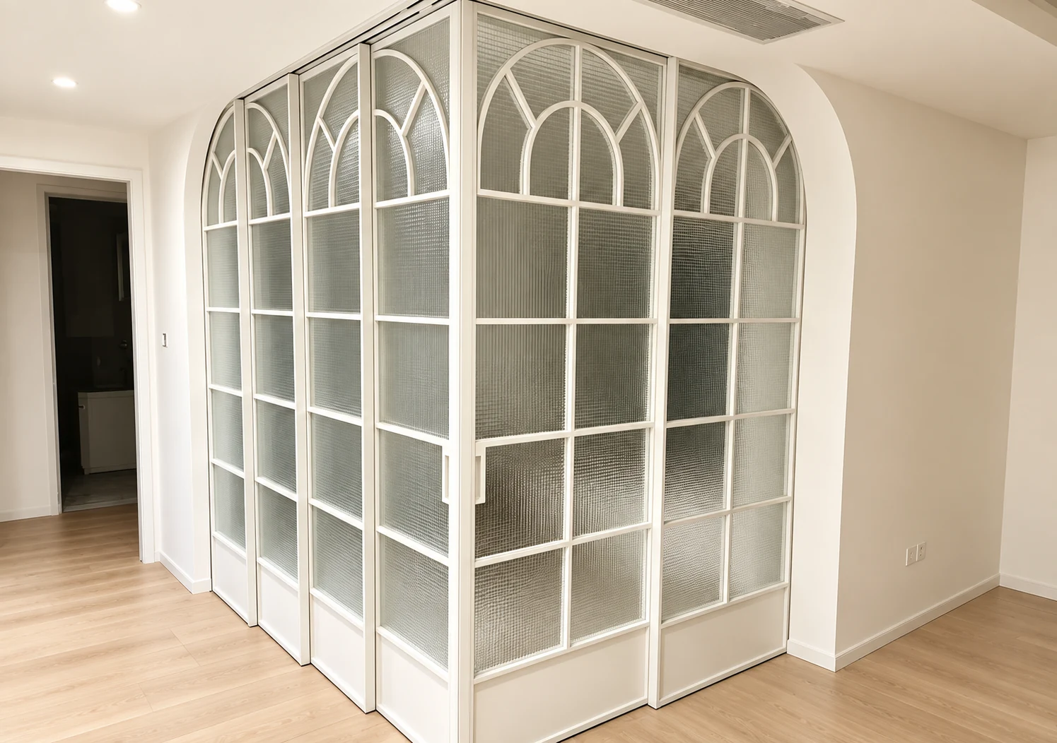 White arched glass partition in a finished interior